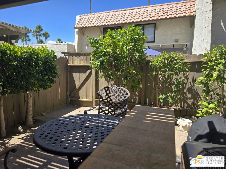365 West Mariscal Road Palm Springs, CA 92262 - Photo 10 of 25 a wooden bench sitting in front of a house