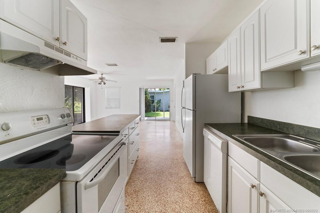 2825 Southeast Pocatella Road Port St. Lucie, FL 34952 - Photo 13 of 36 a kitchen that has a sink and a stove