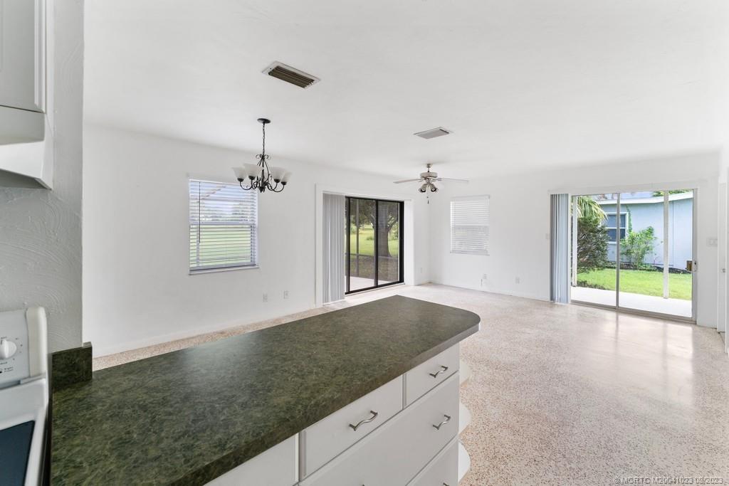 2825 Southeast Pocatella Road Port St. Lucie, FL 34952 - Photo 14 of 36 a view of an empty room with window and wooden floor
