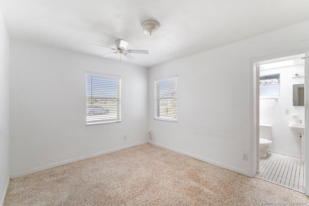 2825 Southeast Pocatella Road Port St. Lucie, FL 34952 - Photo 17 of 36 an empty room with windows and fan