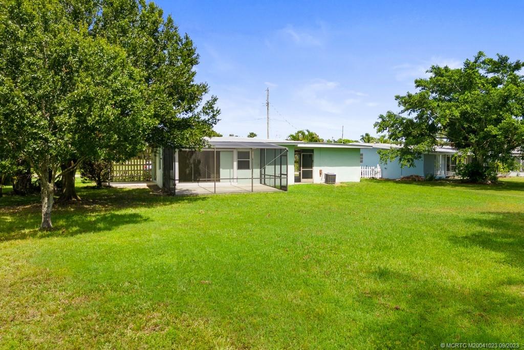 2825 Southeast Pocatella Road Port St. Lucie, FL 34952 - Photo 23 of 36 a front view of a house with garden