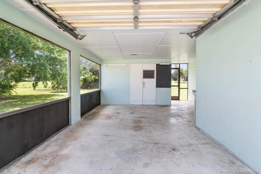 2825 Southeast Pocatella Road Port St. Lucie, FL 34952 - Photo 25 of 36 a view of a hallway with a kitchen