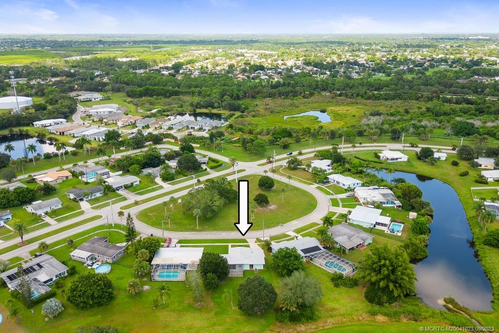 2825 Southeast Pocatella Road Port St. Lucie, FL 34952 - Photo 29 of 36 an aerial view of residential houses with outdoor space and swimming pool