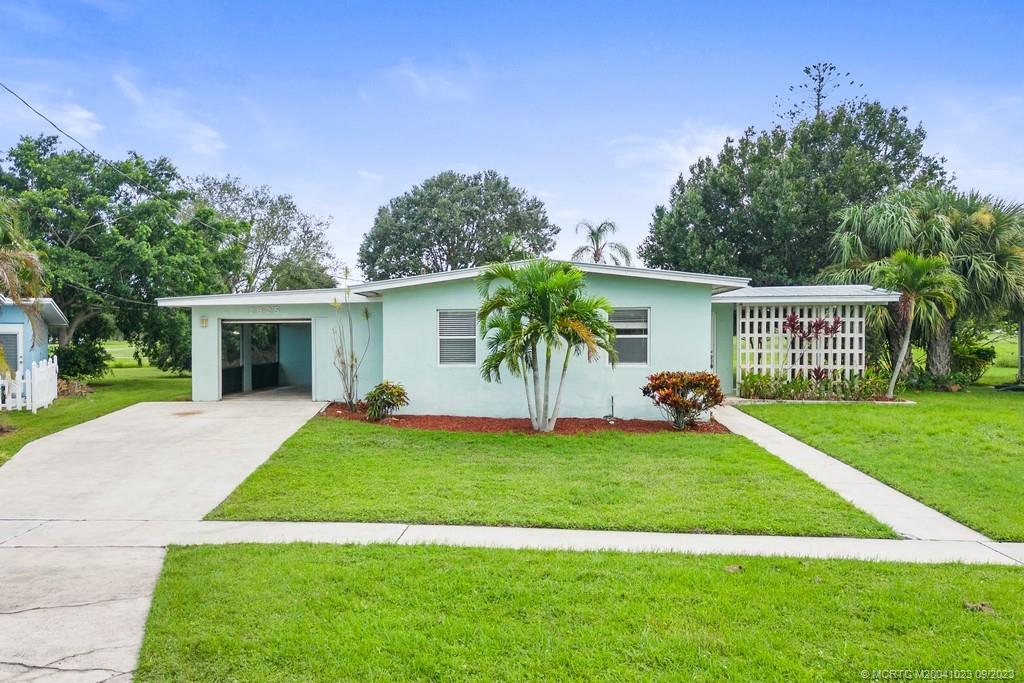 2825 Southeast Pocatella Road Port St. Lucie, FL 34952 - Photo 3 of 36 a view of a house with a yard and a patio