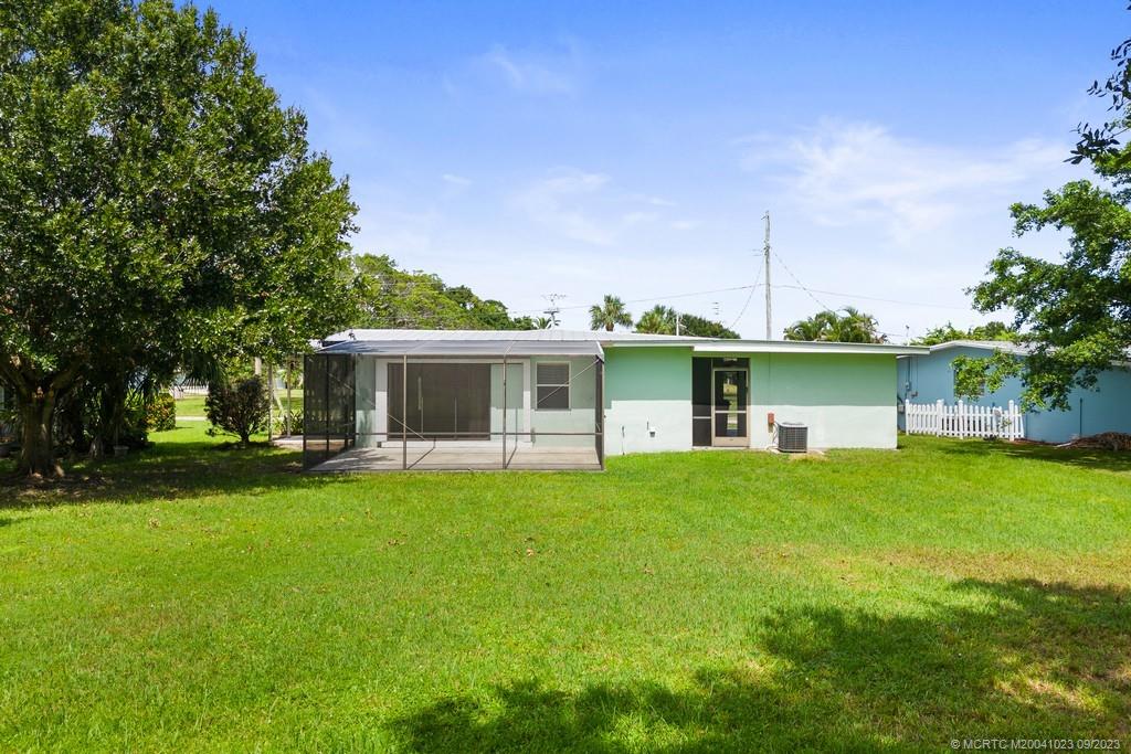 2825 Southeast Pocatella Road Port St. Lucie, FL 34952 - Photo 6 of 36 a front view of house with yard and outdoor seating