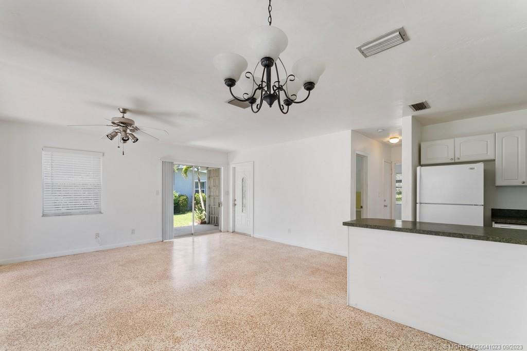 2825 Southeast Pocatella Road Port St. Lucie, FL 34952 - Photo 8 of 36 a view of a chandelier fan and kitchen view