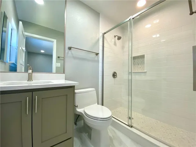 a bathroom with a sink toilet and shower