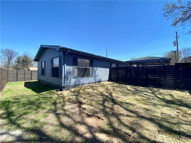 a view of a house with wooden fence