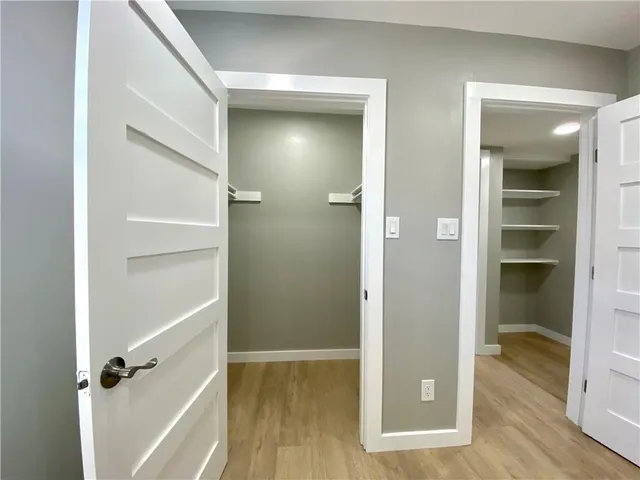 walk in closet with wooden floor