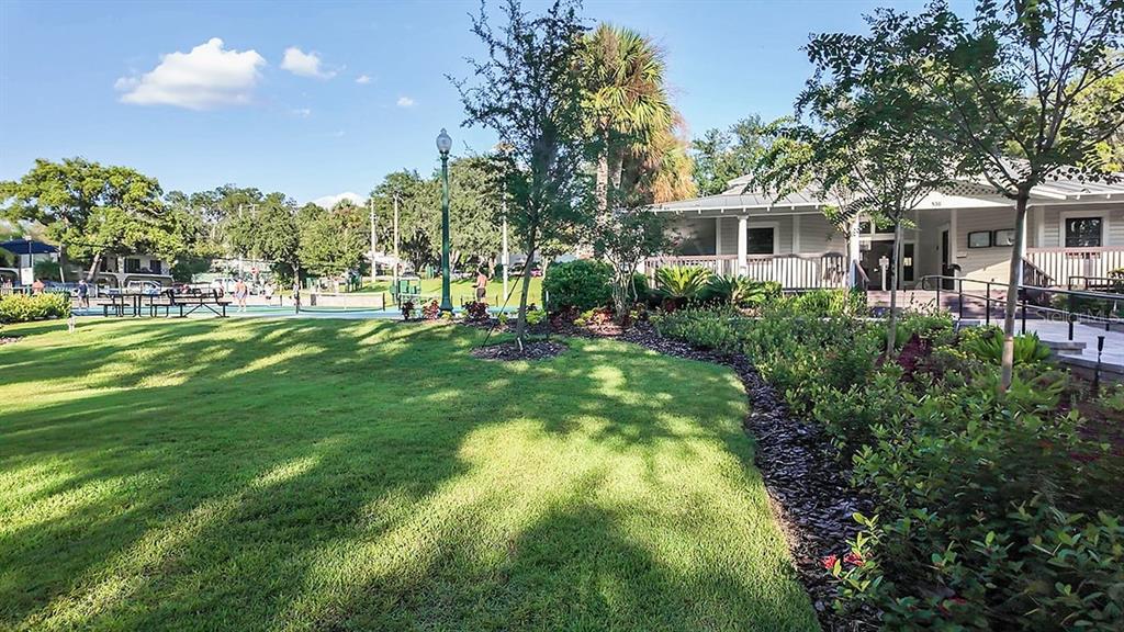 690 Gladstone Way Mount Dora, FL 32757 - Photo 20 of 25 a front view of a house with a yard