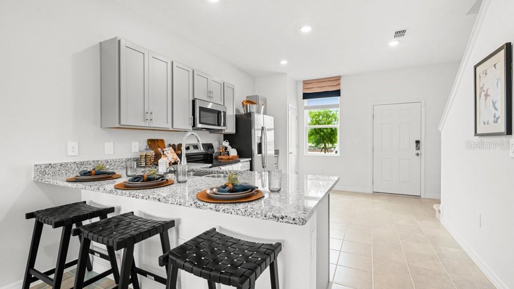 690 Gladstone Way Mount Dora, FL 32757 - Photo 5 of 25 a view of a dining room with furniture and a window