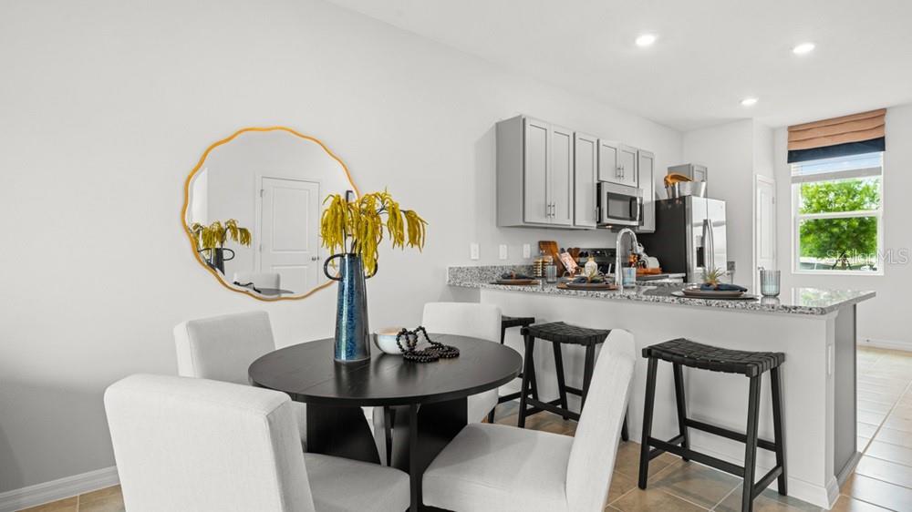 690 Gladstone Way Mount Dora, FL 32757 - Photo 7 of 25 a kitchen with a table chairs and a sink