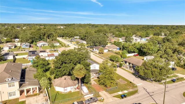 an aerial view of a house with a yard basket ball court and outdoor seating