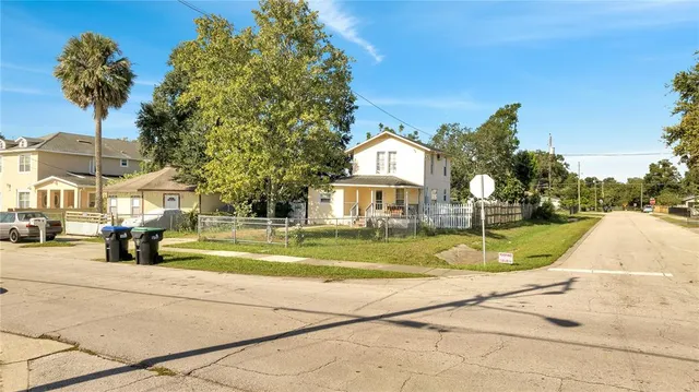 an aerial view of a house with a yard