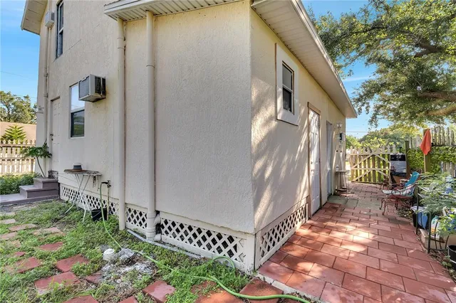 a view of an empty room with glass door and wooden floor