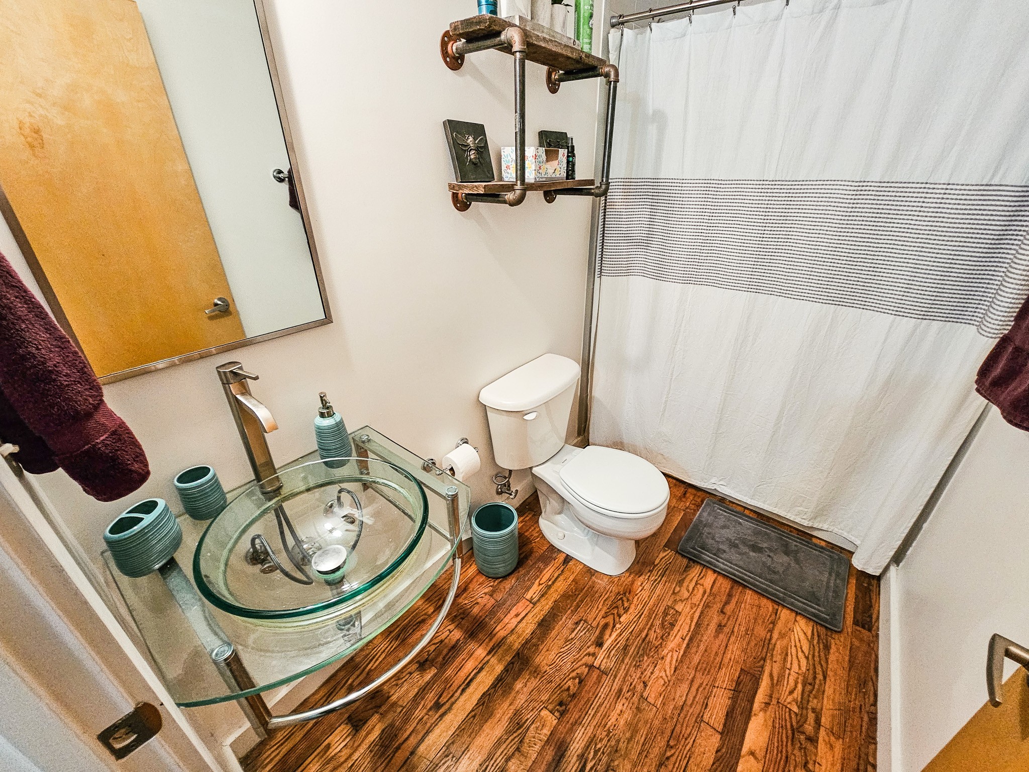 231 Rep. John Lewis Way North, Unit 406 Nashville, TN 37219 - Photo 11 of 30 a bathroom with a sink mirror vanity and toilet