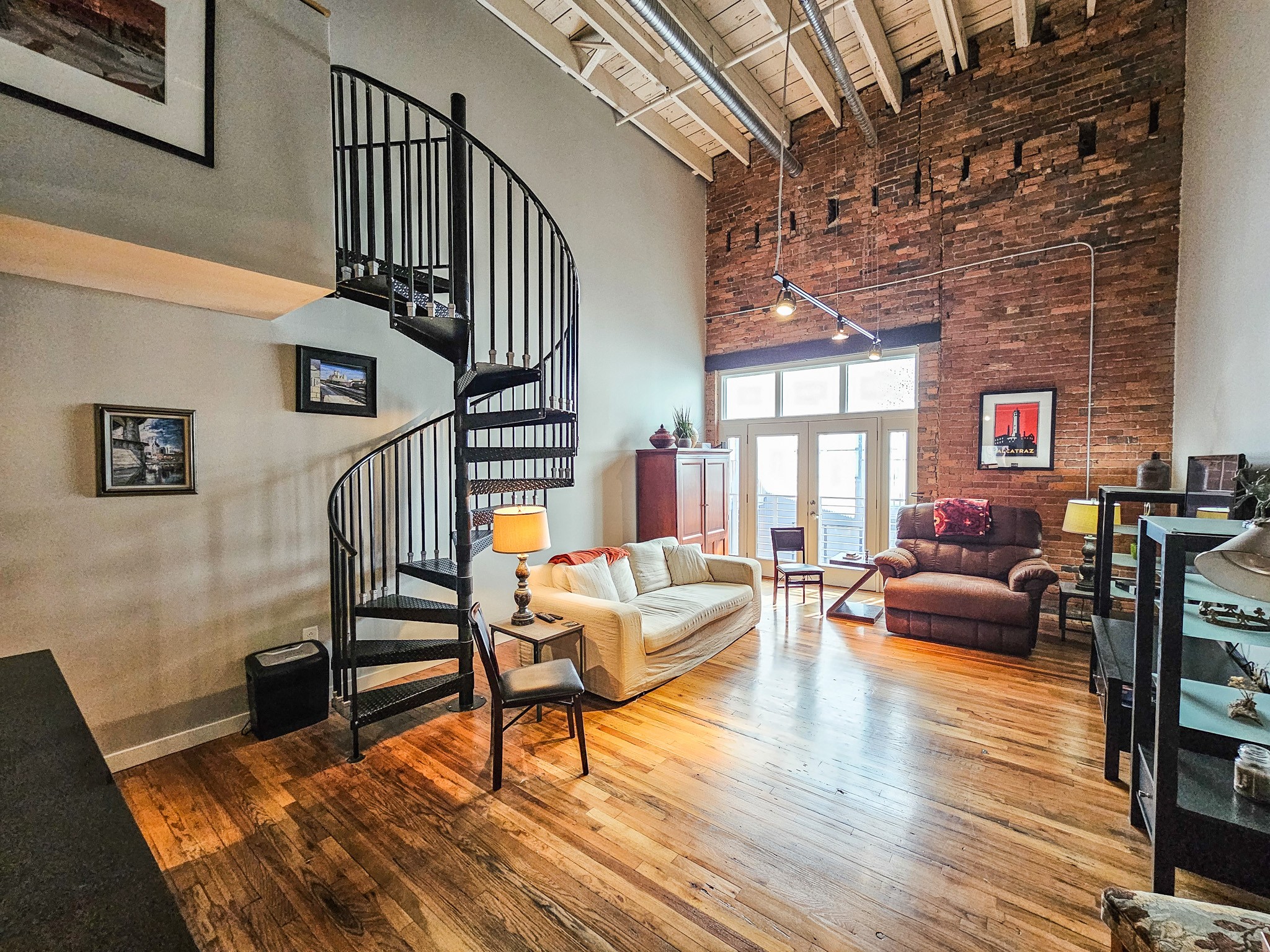 231 Rep. John Lewis Way North, Unit 406 Nashville, TN 37219 - Photo 16 of 30 a living room with furniture and a wooden floor
