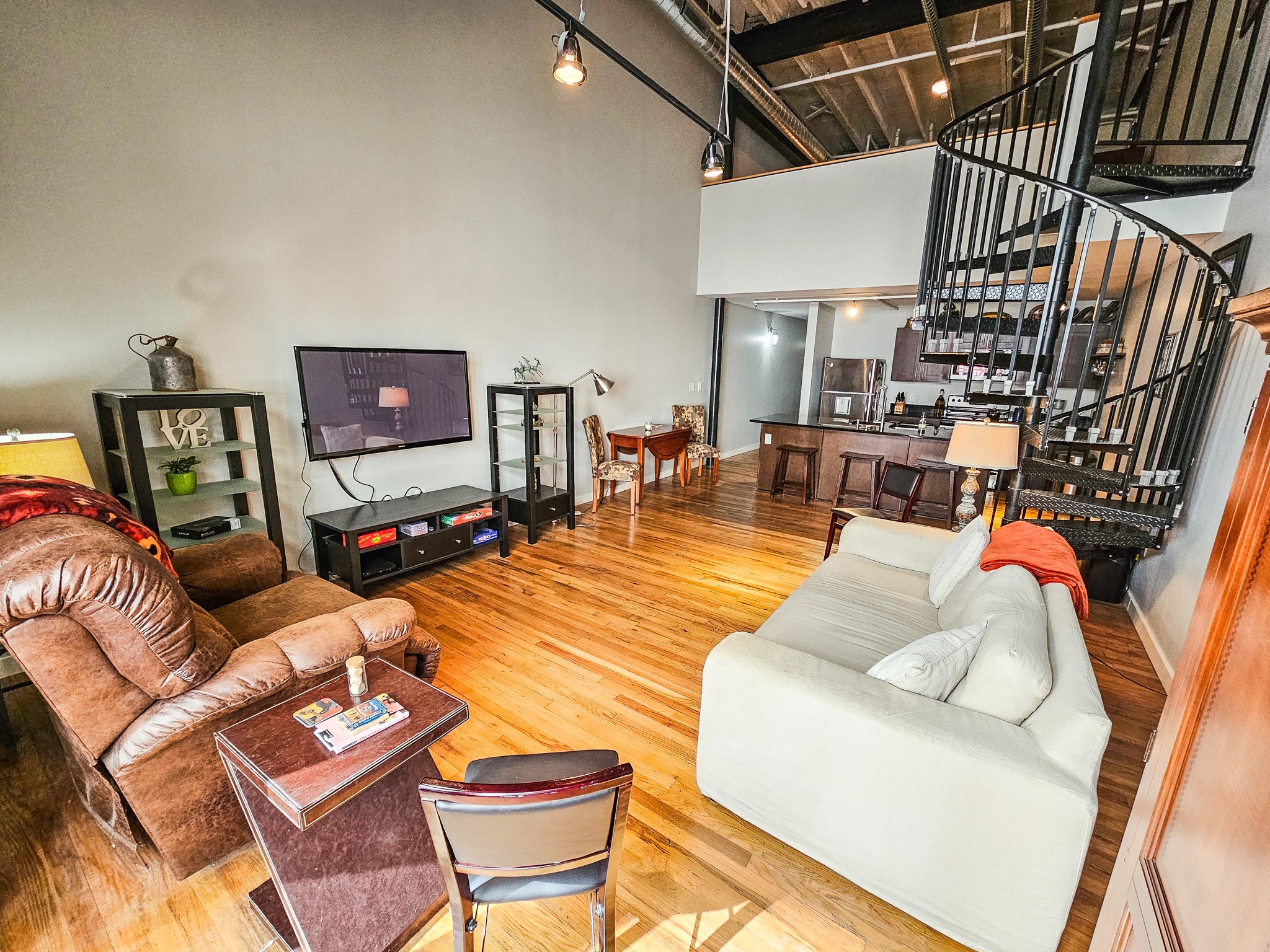 231 Rep. John Lewis Way North, Unit 406 Nashville, TN 37219 - Photo 17 of 30 a living room with furniture and a flat screen tv
