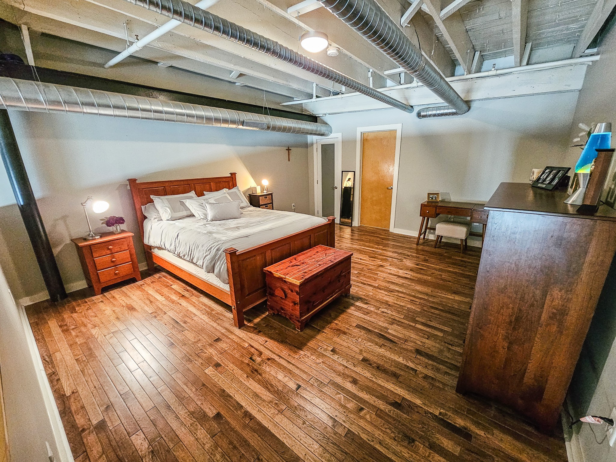 231 Rep. John Lewis Way North, Unit 406 Nashville, TN 37219 - Photo 19 of 30 a bedroom with a bed and wooden floor