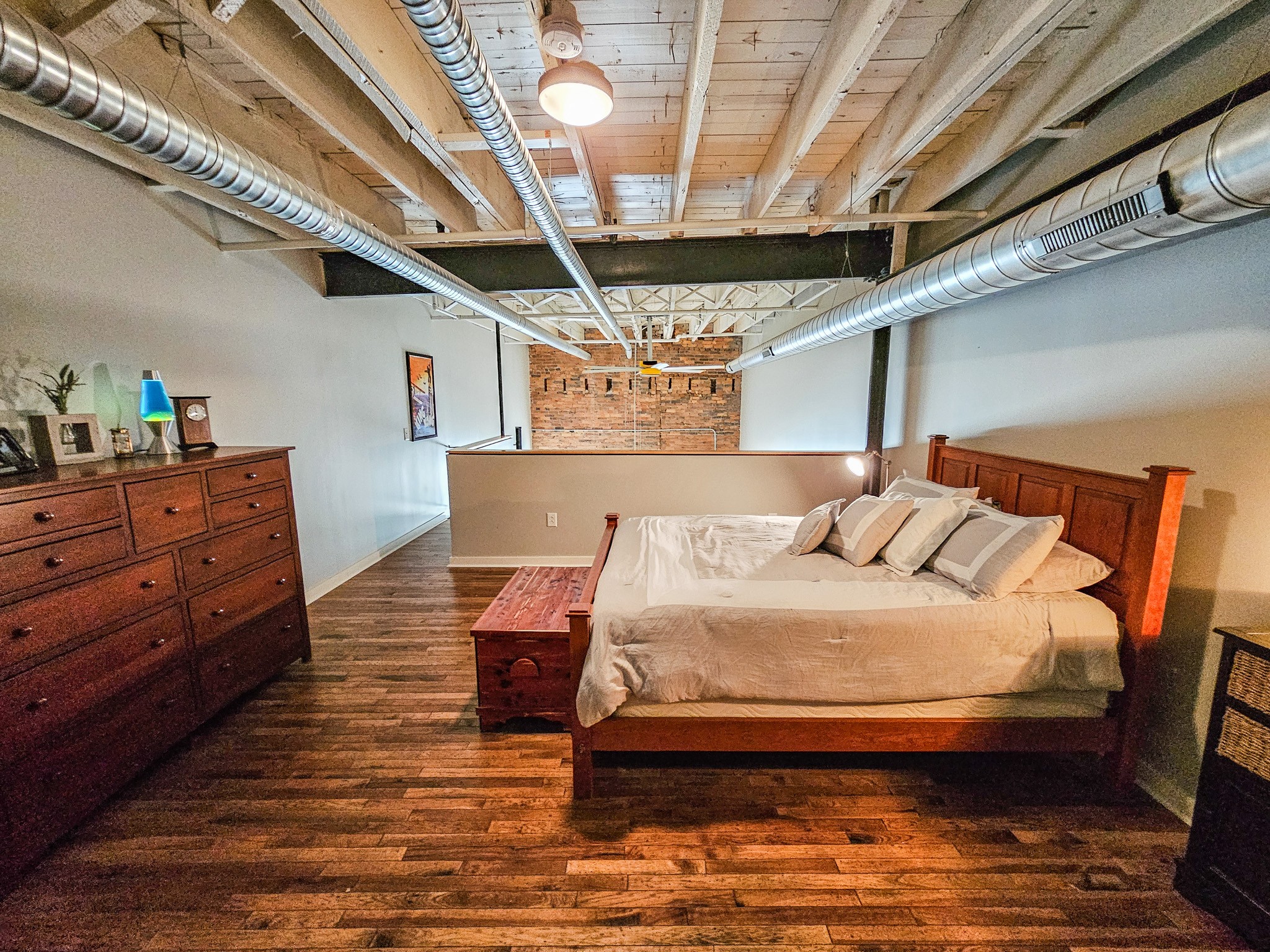 231 Rep. John Lewis Way North, Unit 406 Nashville, TN 37219 - Photo 21 of 30 a bedroom with a bed and a chandelier