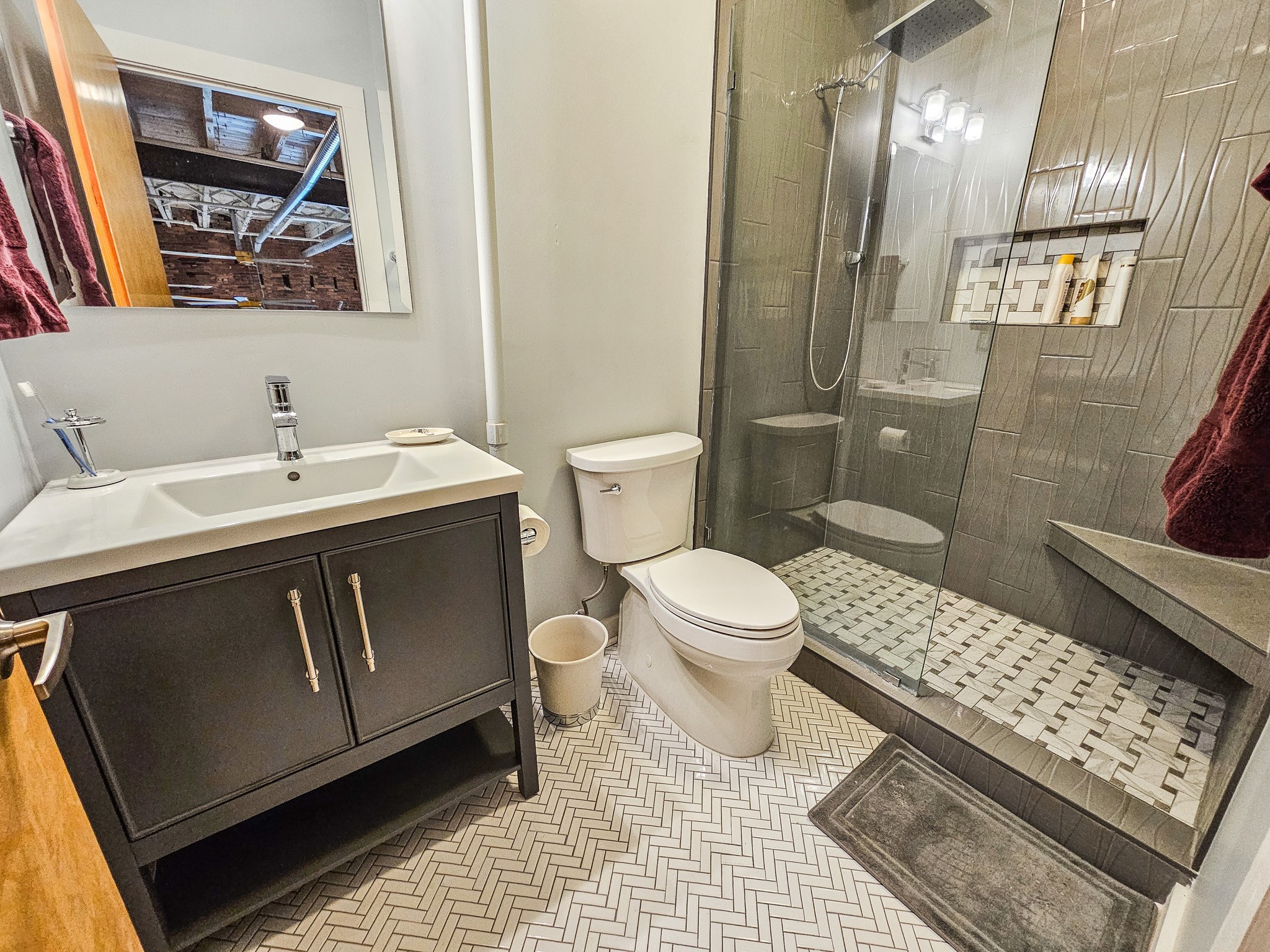 231 Rep. John Lewis Way North, Unit 406 Nashville, TN 37219 - Photo 23 of 30 a bathroom with a sink toilet and shower