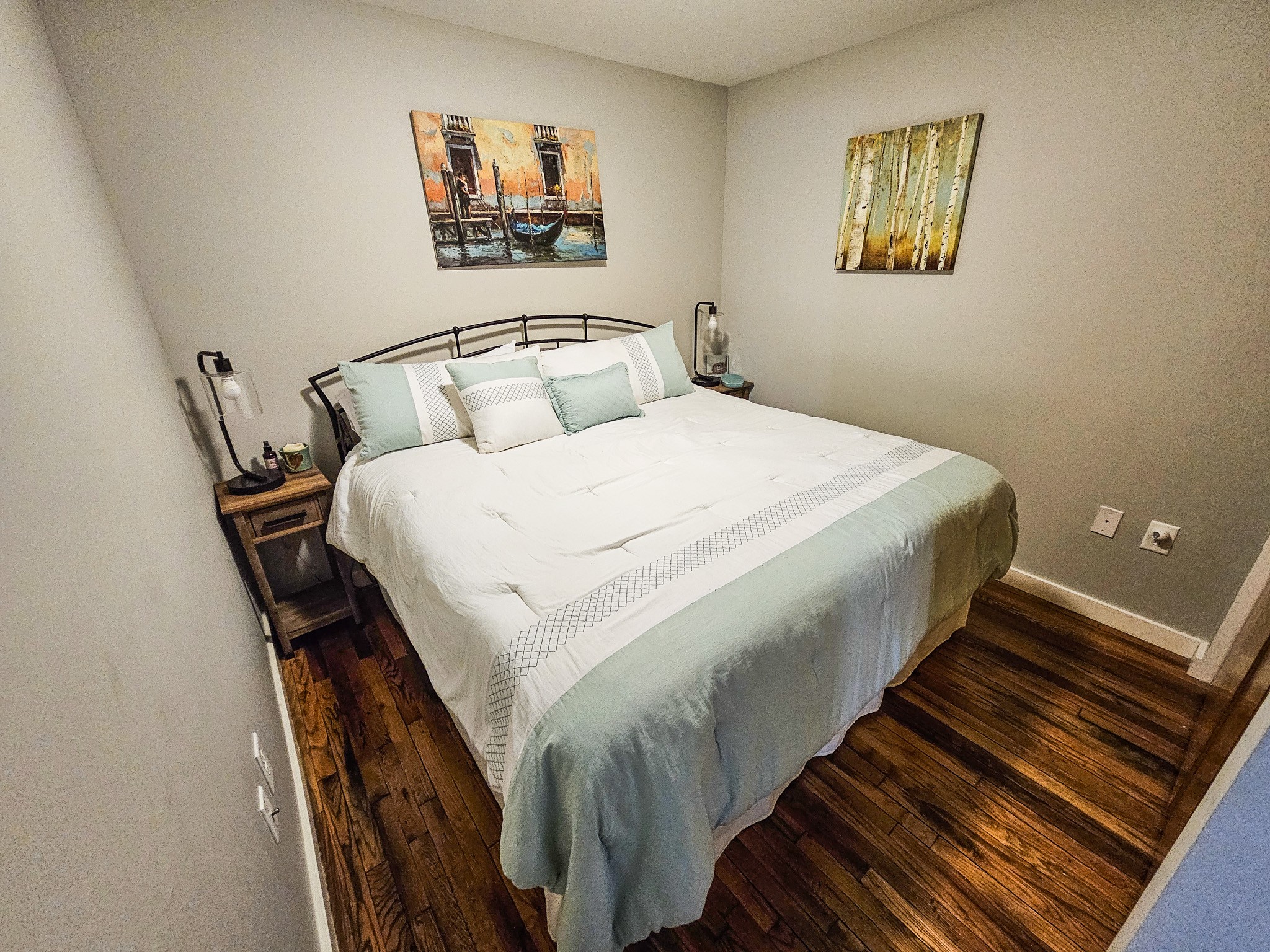 231 Rep. John Lewis Way North, Unit 406 Nashville, TN 37219 - Photo 9 of 30 a bedroom with bed and wall painting