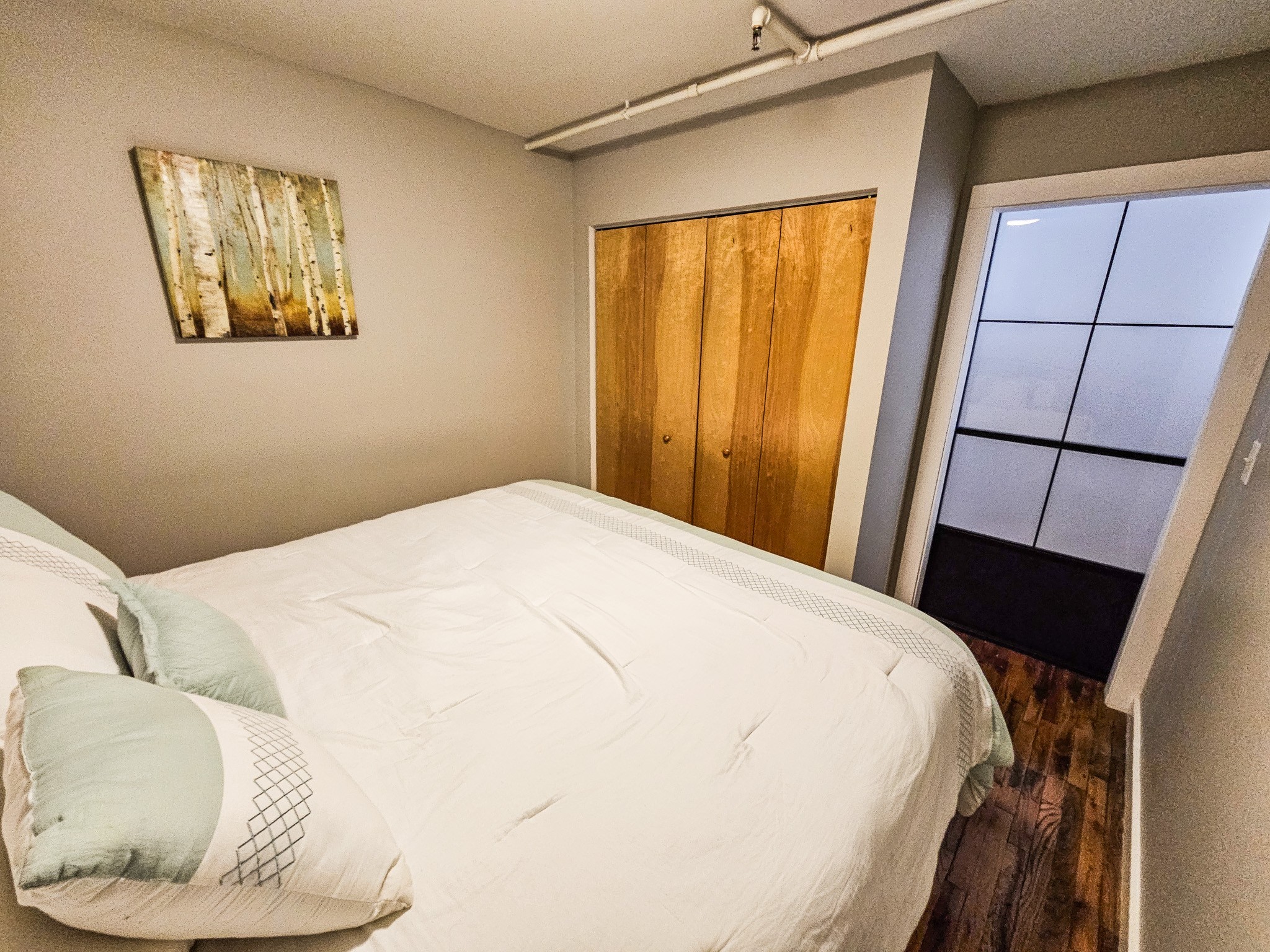 231 Rep. John Lewis Way North, Unit 406 Nashville, TN 37219 - Photo 10 of 30 a bedroom with a bed and a painting on the wall