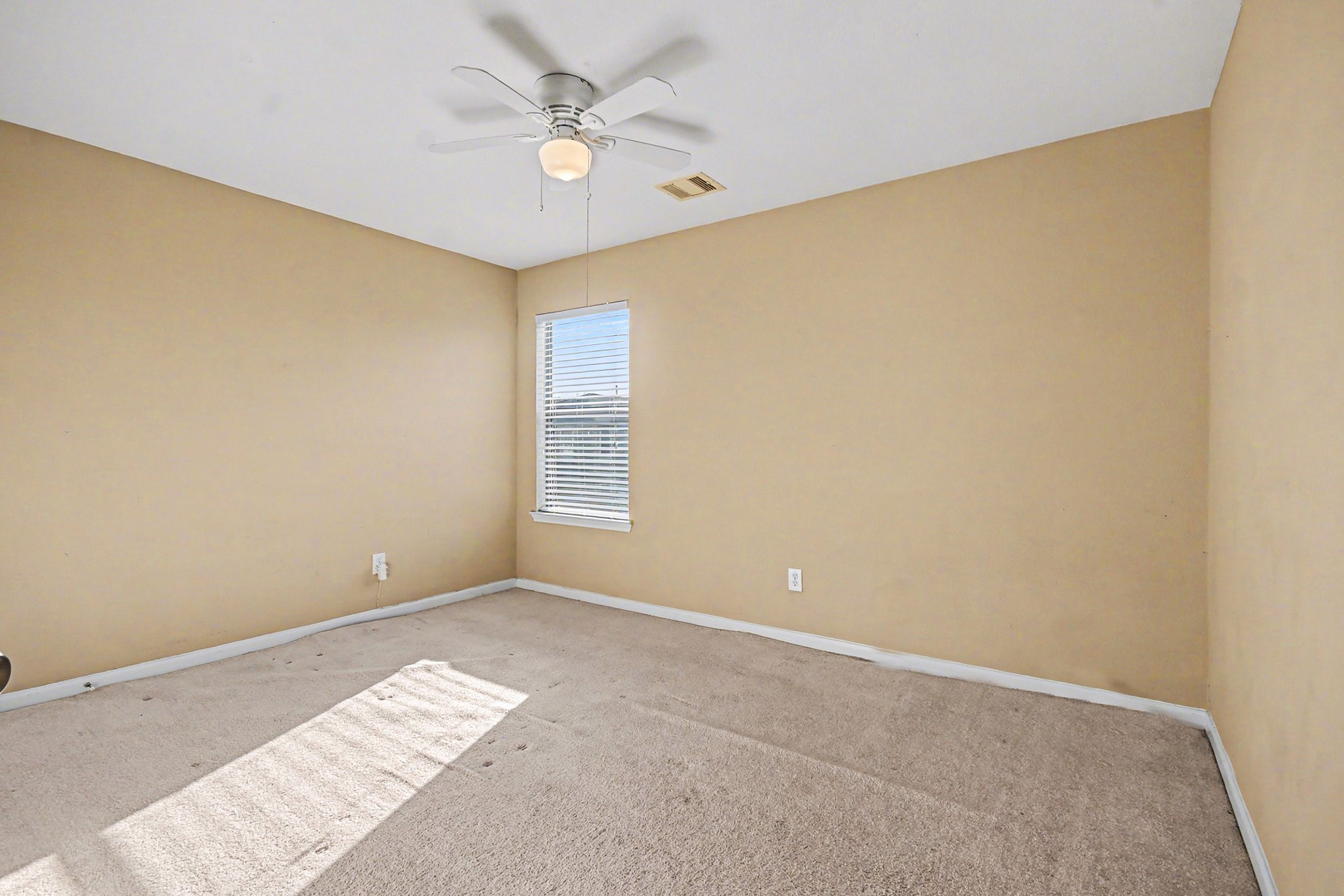 6703 Providence View Lane Houston, TX 77049 - Photo 11 of 21 a view of room with window and ceiling fan