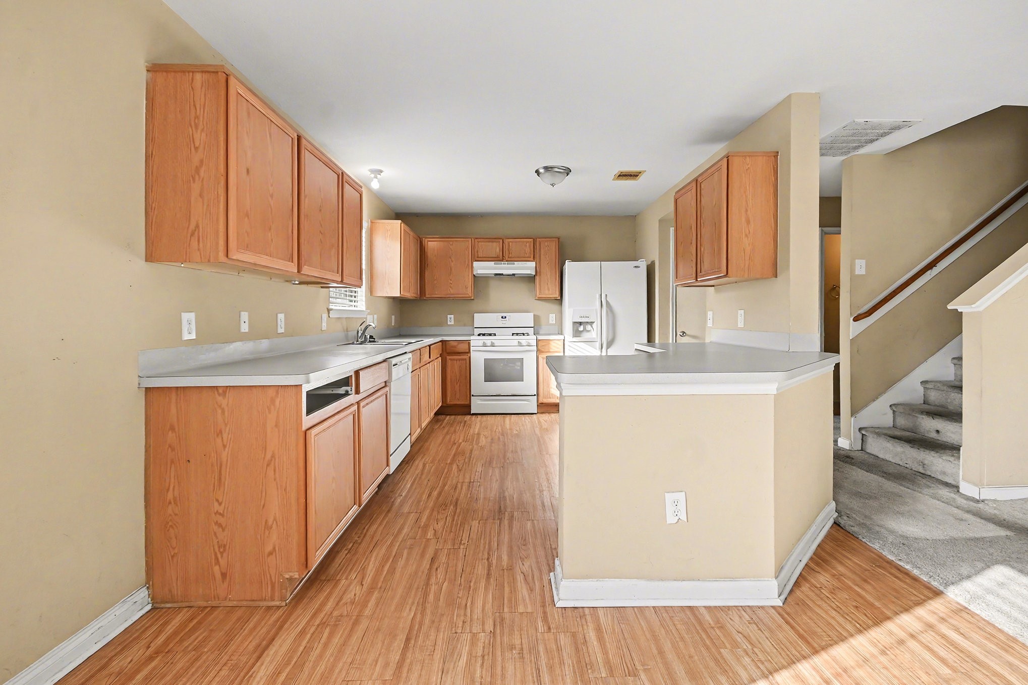 6703 Providence View Lane Houston, TX 77049 - Photo 18 of 21 a kitchen with stainless steel appliances granite countertop a stove a sink dishwasher and a refrigerator with wooden floor