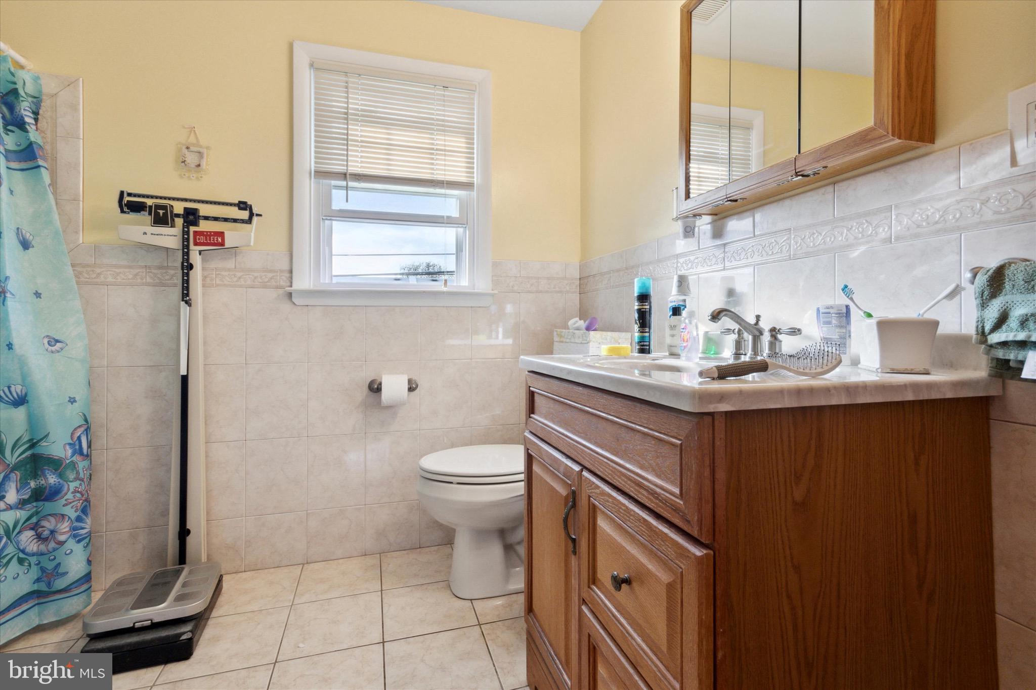 602 Wynnbrook Road Secane, PA 19018 - Photo 12 of 16 a bathroom with a sink a toilet and a mirror