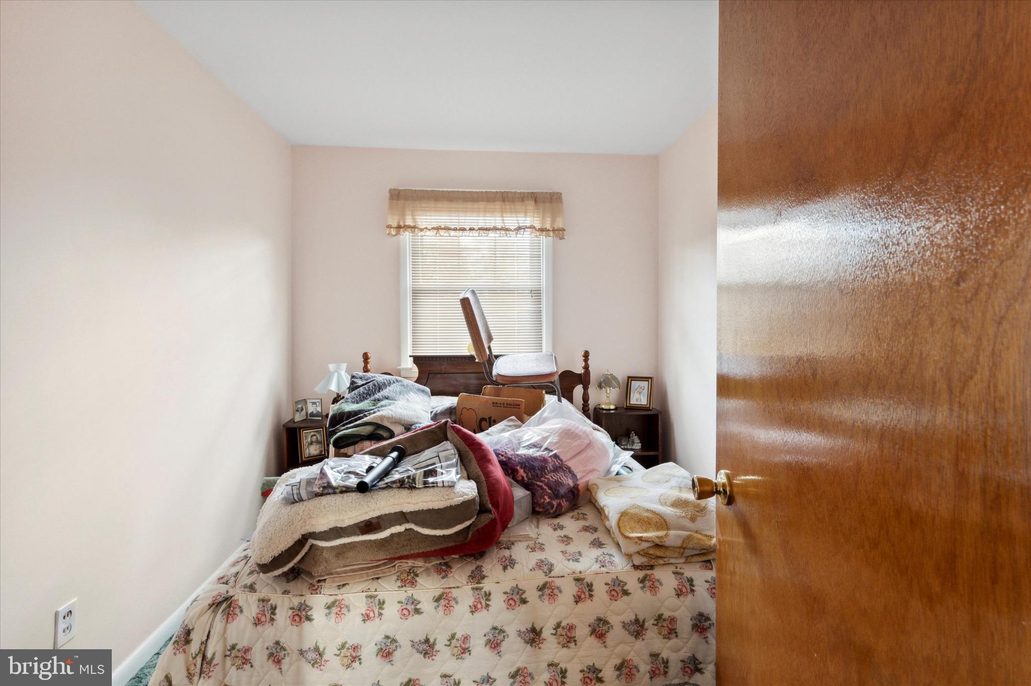 602 Wynnbrook Road Secane, PA 19018 - Photo 13 of 16 a bed sitting in a bedroom next to a window