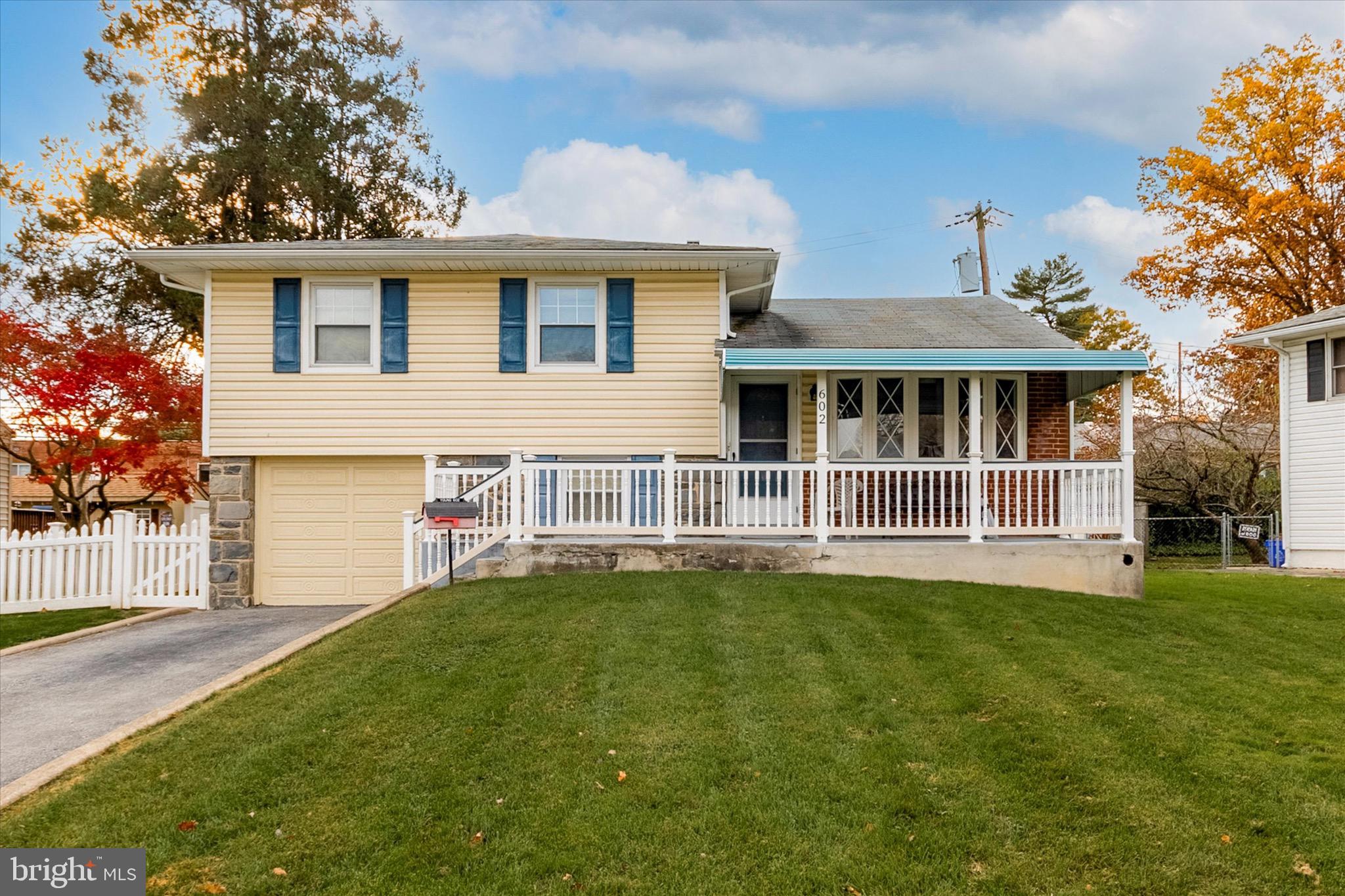 602 Wynnbrook Road Secane, PA 19018 - Photo 16 of 16 a front view of a house with a garden and trees