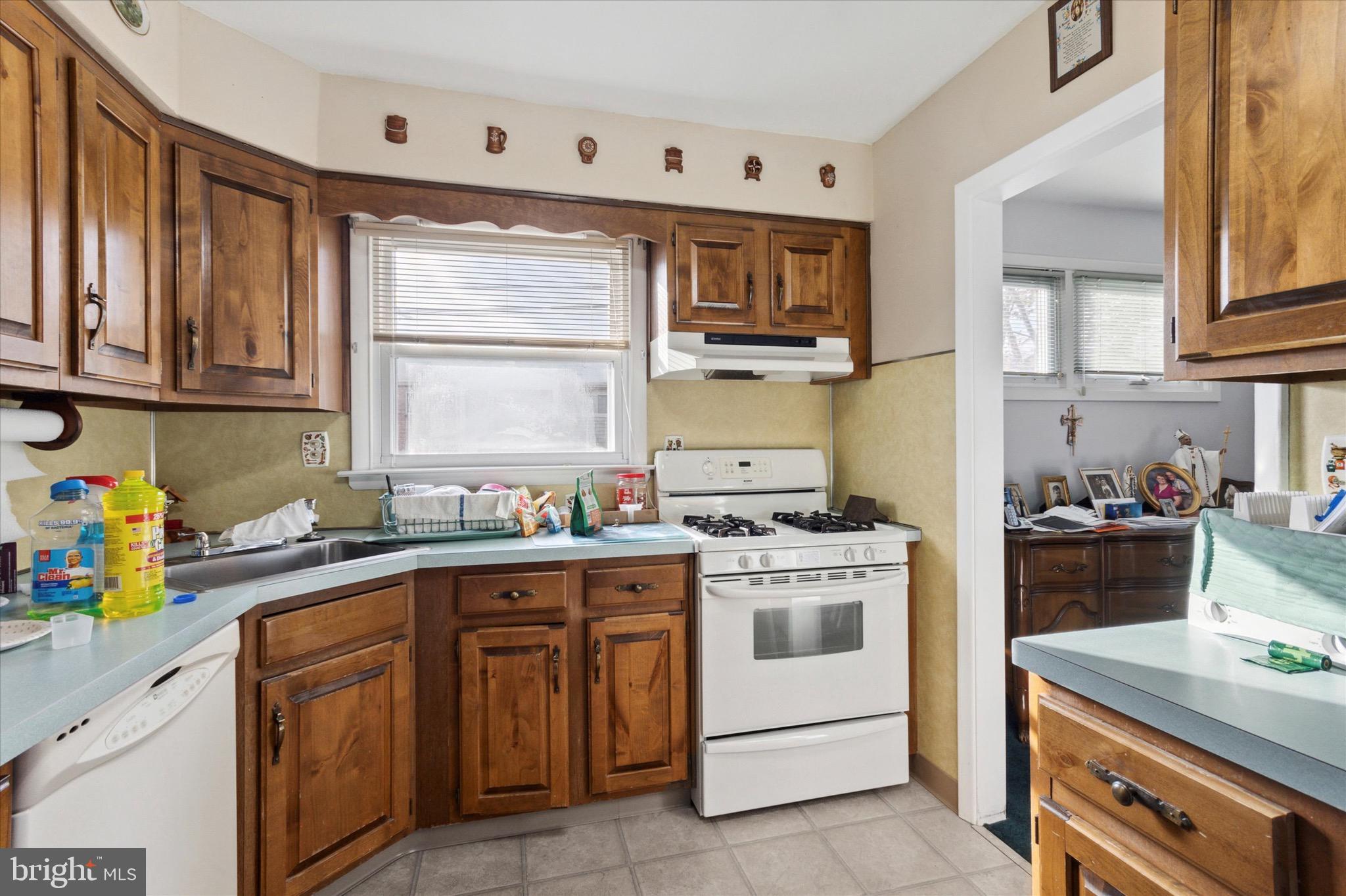 602 Wynnbrook Road Secane, PA 19018 - Photo 7 of 16 a kitchen with a stove top oven sink and cabinets