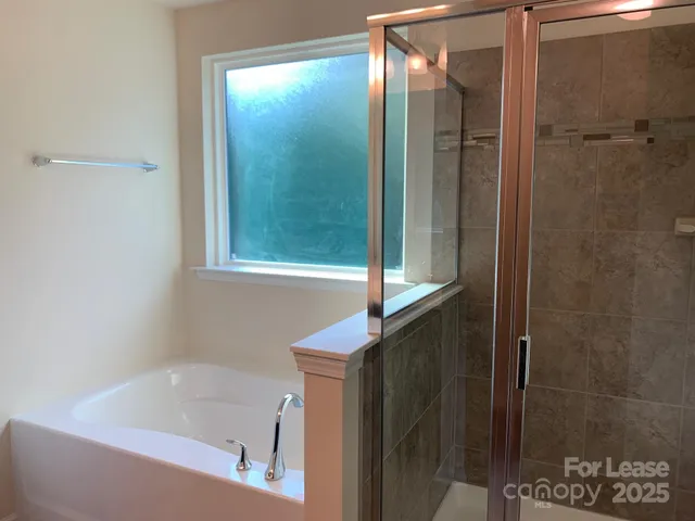 a bathroom with a shower and a sink
