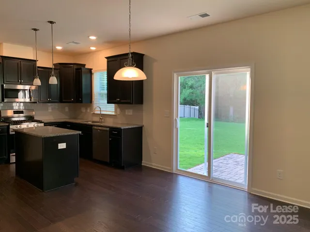 a kitchen with kitchen island a counter space a sink and appliances