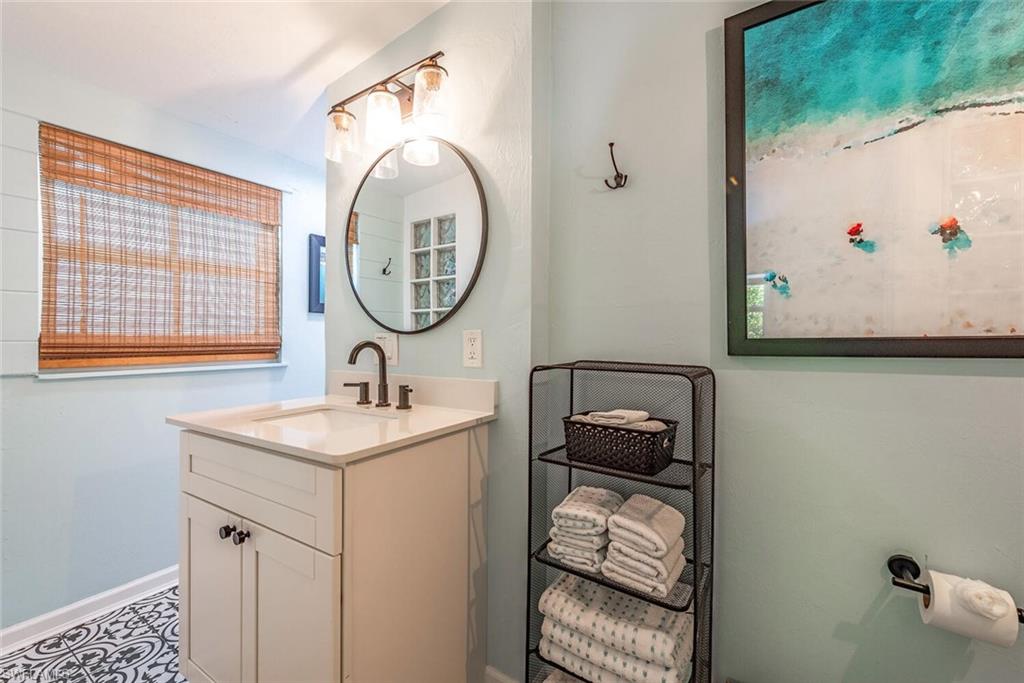 1971 Holiday Lane Naples, FL 34104 - Photo 15 of 26 a bathroom with a sink and a mirror