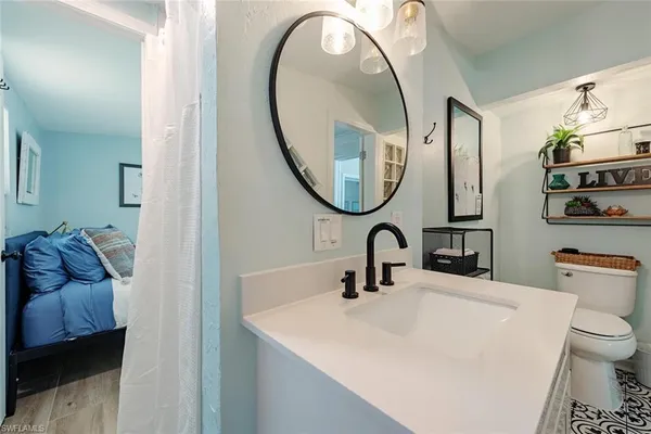 a bathroom with a toilet sink and mirror