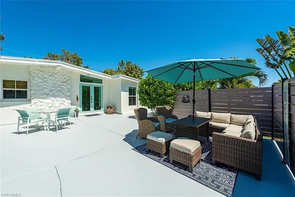 a view of a backyard with a patio and outdoor seating