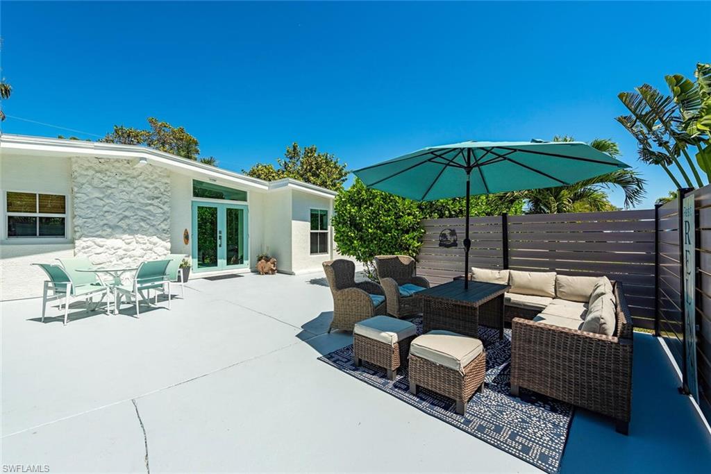 1971 Holiday Lane Naples, FL 34104 - Photo 2 of 26 a view of a backyard with a patio and outdoor seating