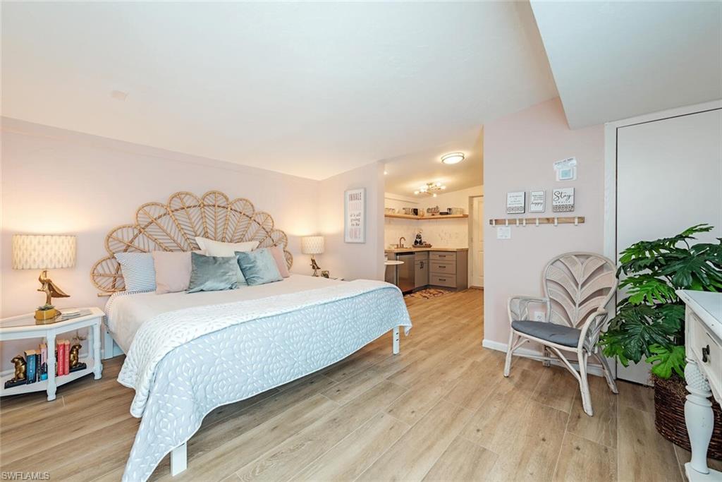 1971 Holiday Lane Naples, FL 34104 - Photo 23 of 26 a bedroom with a bed and a chair in it