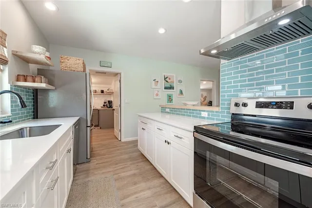 a kitchen with sink cabinets and stove top oven