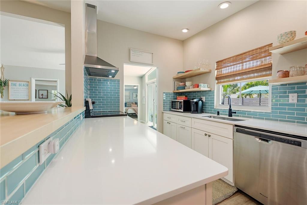 1971 Holiday Lane Naples, FL 34104 - Photo 6 of 26 a large kitchen with stainless steel appliances a large window in it