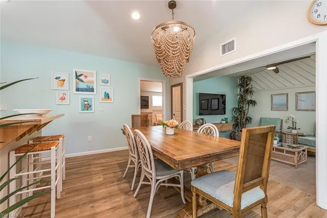 a dining room with furniture window and wooden floor