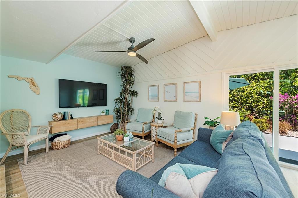 1971 Holiday Lane Naples, FL 34104 - Photo 10 of 26 a living room with furniture and a flat screen tv