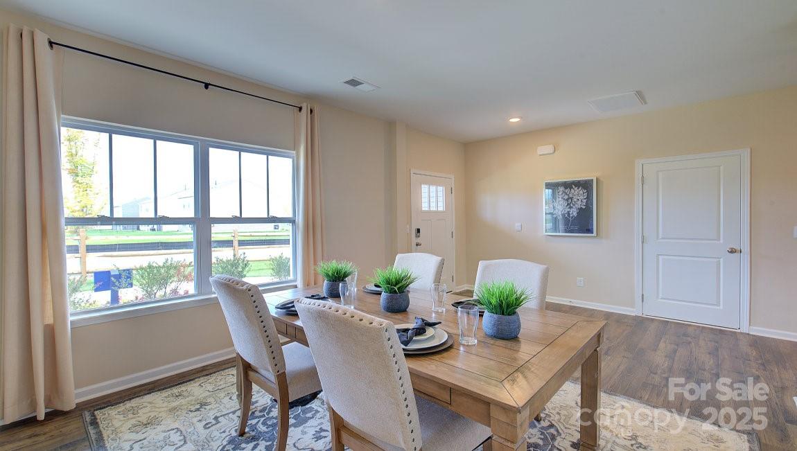 145 Bovine Br Road Fletcher, NC 28732 - Photo 13 of 43 a view of a dining room with furniture a rug and wooden floor