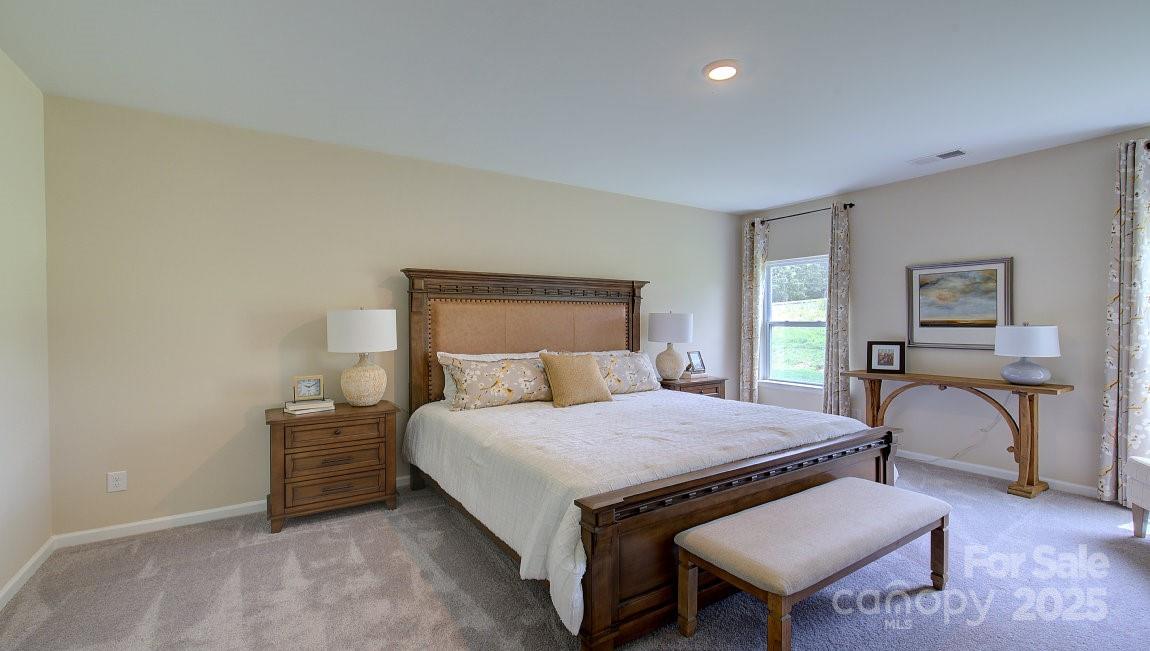 145 Bovine Br Road Fletcher, NC 28732 - Photo 17 of 43 a bedroom with a bed and a table in it