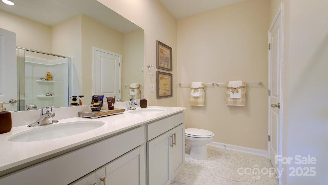 145 Bovine Br Road Fletcher, NC 28732 - Photo 18 of 43 a bathroom with a sink a toilet and a mirror
