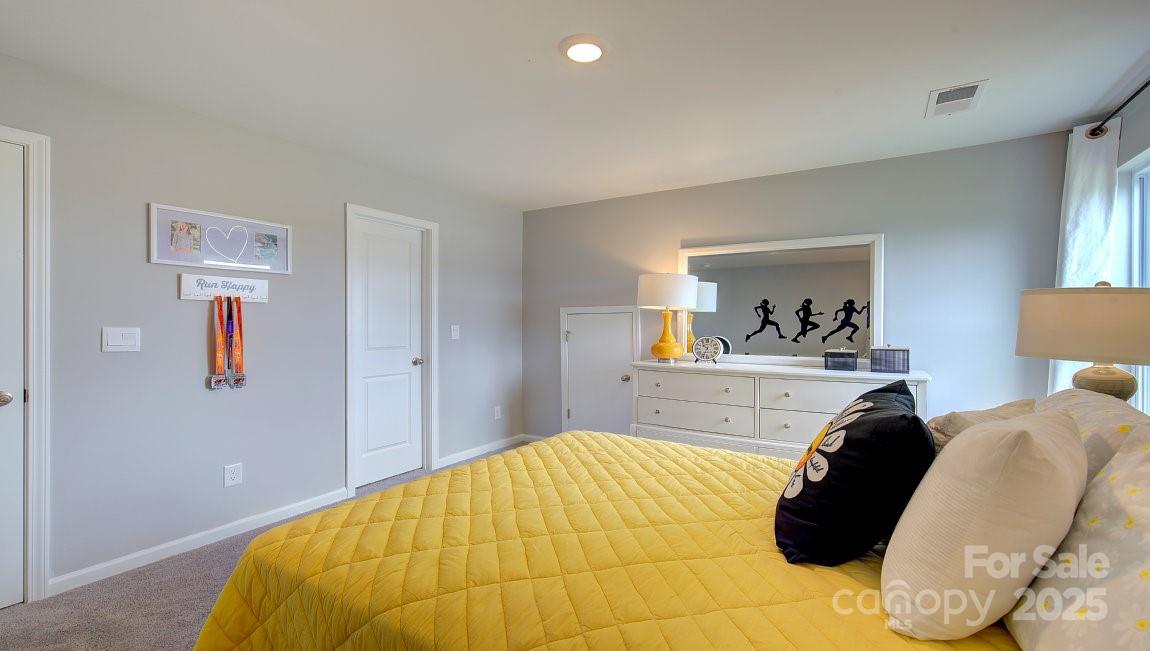 145 Bovine Br Road Fletcher, NC 28732 - Photo 25 of 43 a bedroom with a bed and wall painting