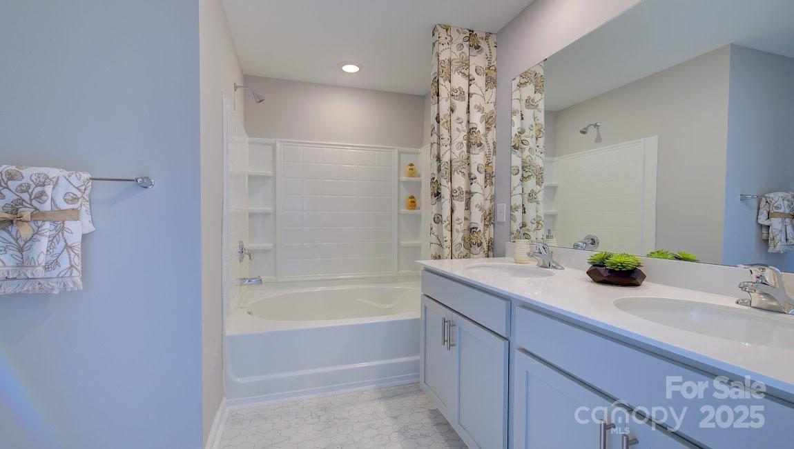145 Bovine Br Road Fletcher, NC 28732 - Photo 29 of 43 a bathroom with a bathtub sink and mirror