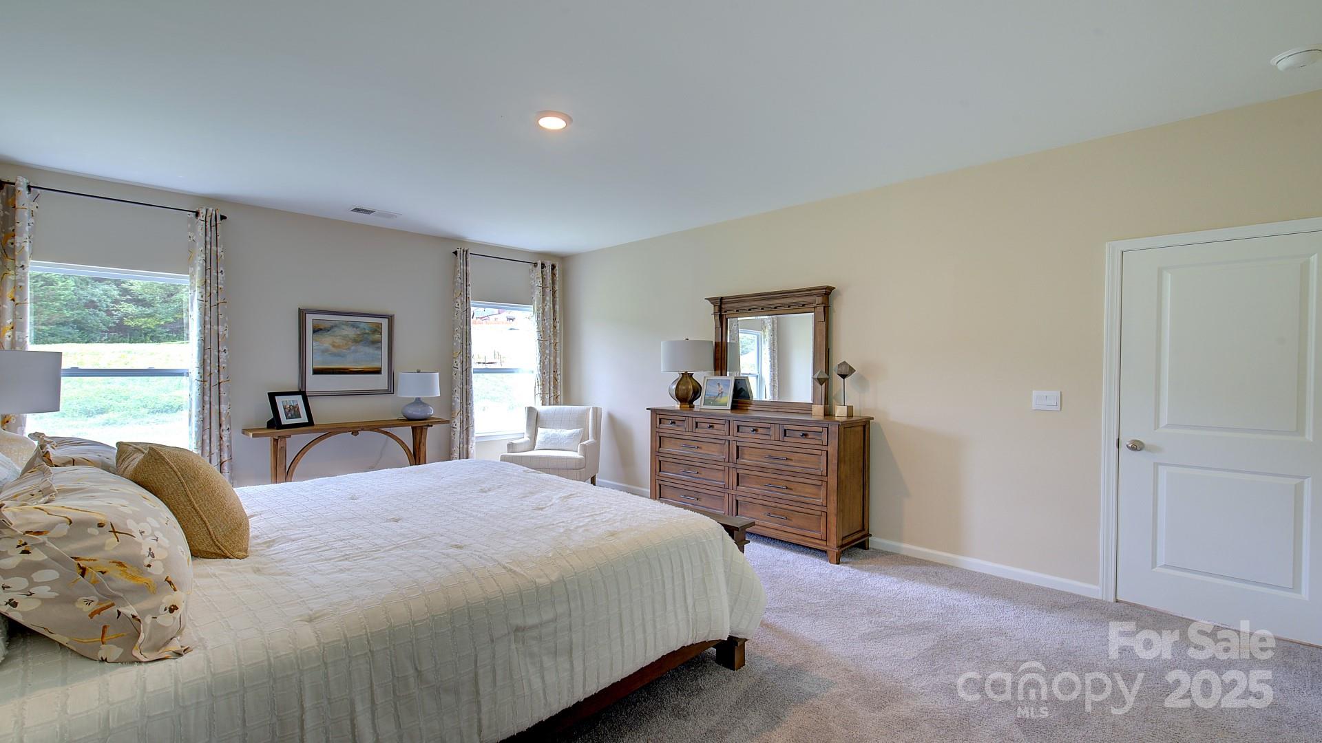 145 Bovine Br Road Fletcher, NC 28732 - Photo 32 of 43 a bedroom with a large bed and wooden floor
